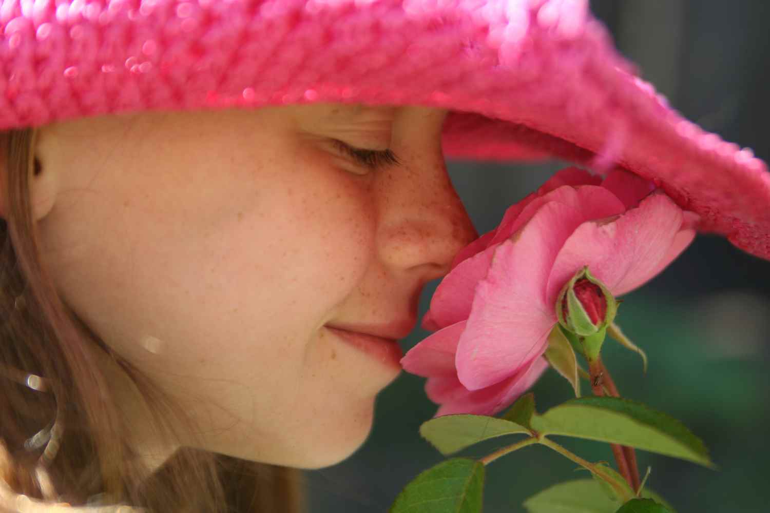 little girl smelling a flower
